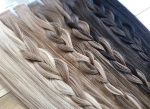A variety of tape style hair extensions ranging from platinum to black